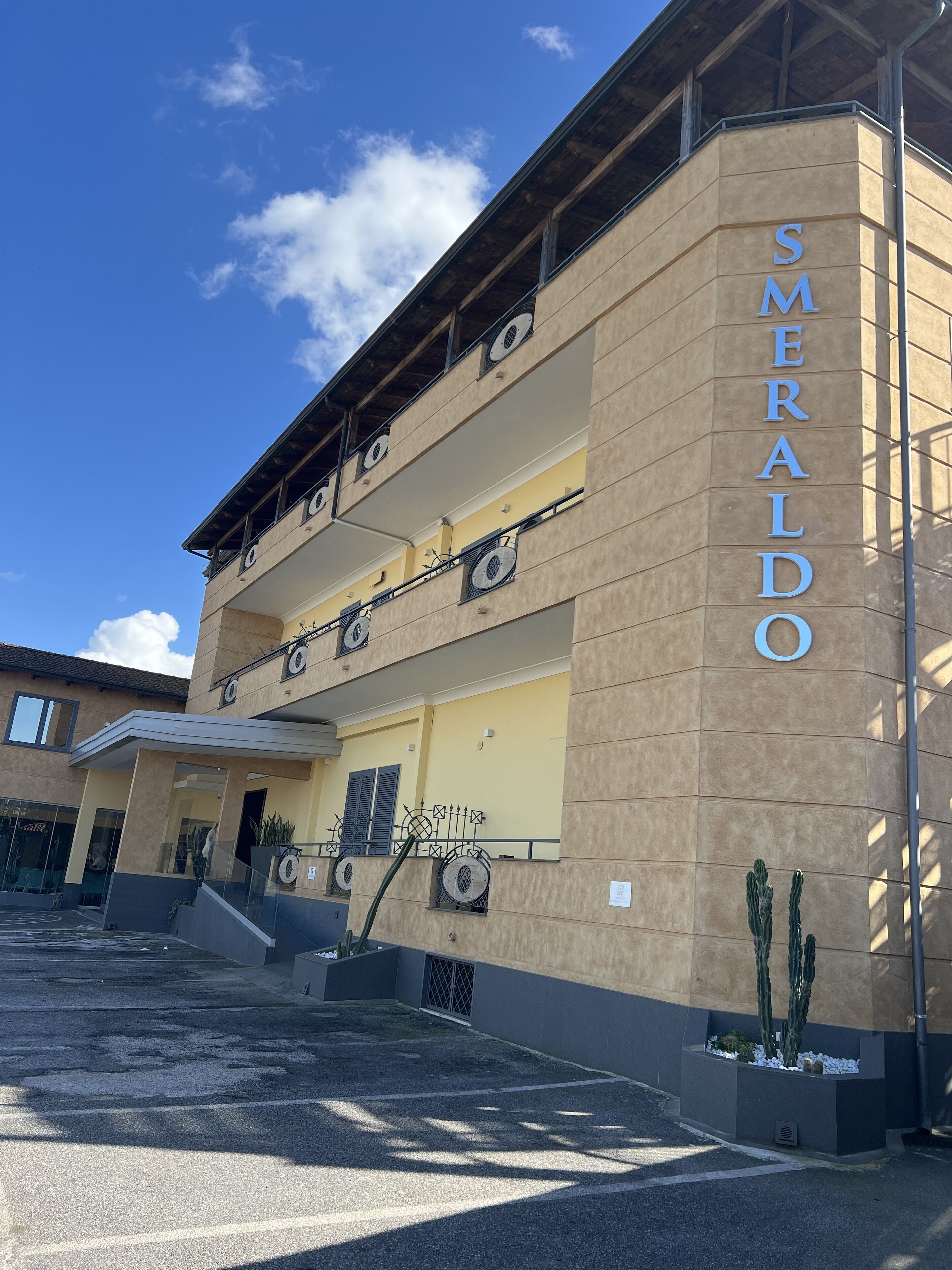 A multi-story building with the name 'SMERALDO' on the facade.
