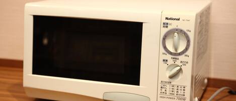 A white National microwave oven with a digital timer and a power button.