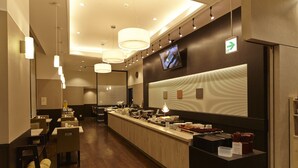 A modern hotel lobby with a long reception desk, seating area, and a television mounted on the wall. - Dormy Inn Express Sendai Hirosedori Hot Spring (Sendai)
