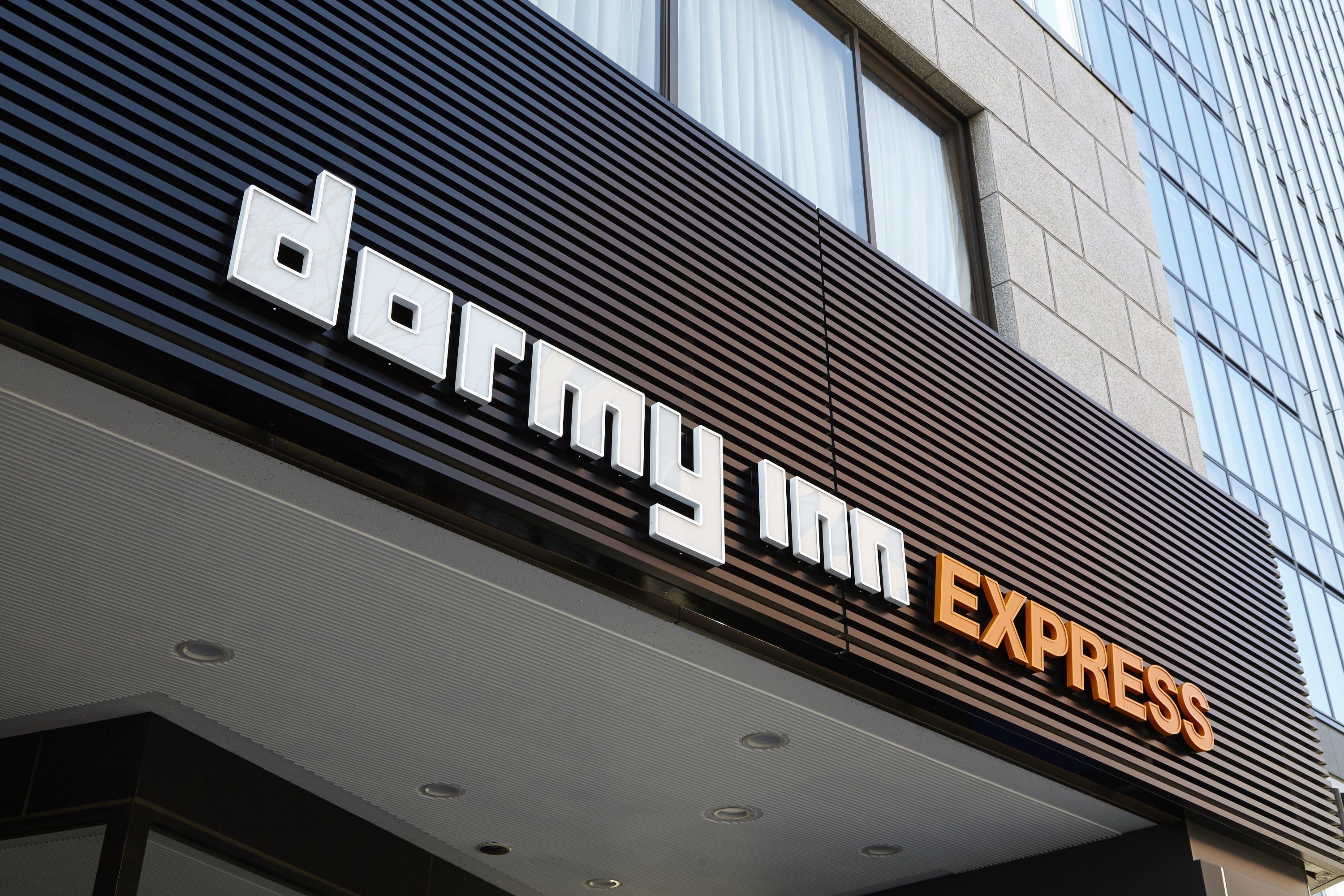 A building with a sign that reads "dormy inn EXPRESS".