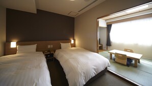 A hotel room with two beds, a desk, and a large mirror. - Dormy Inn Express Sendai Hirosedori Hot Spring (Sendai)