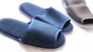 A pair of blue and brown slippers with a textured surface.