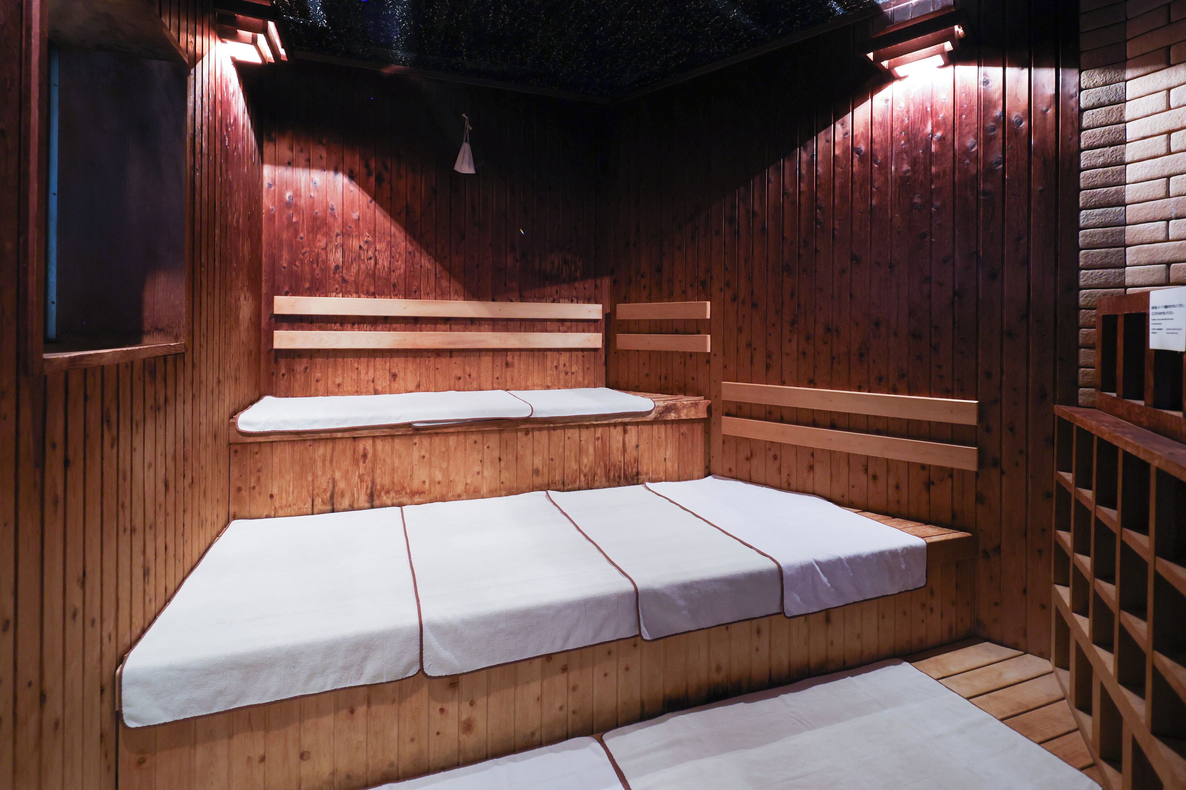 A wooden sauna with benches and a bench seat.