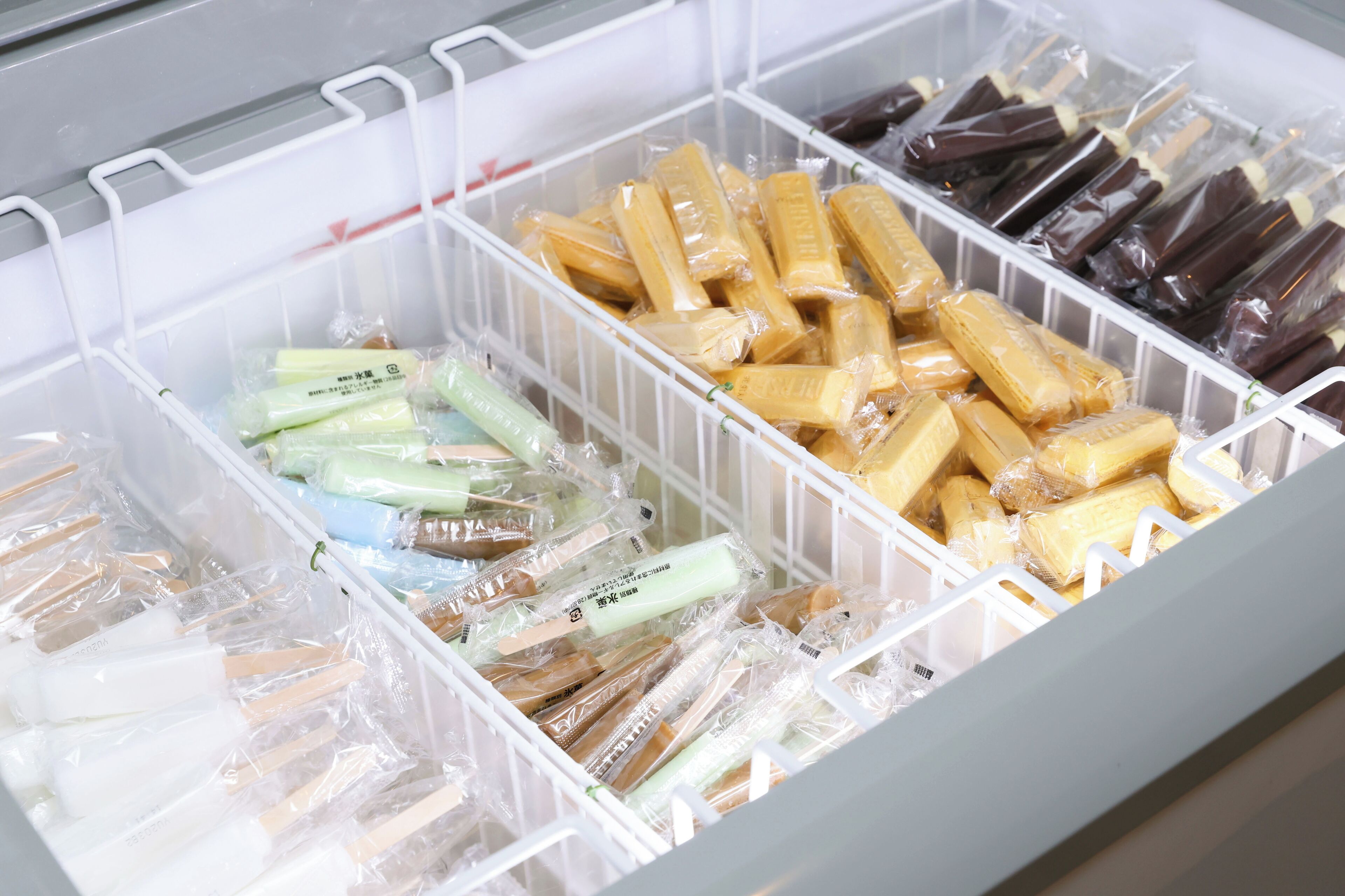 A storage unit with multiple compartments containing various packaged items.