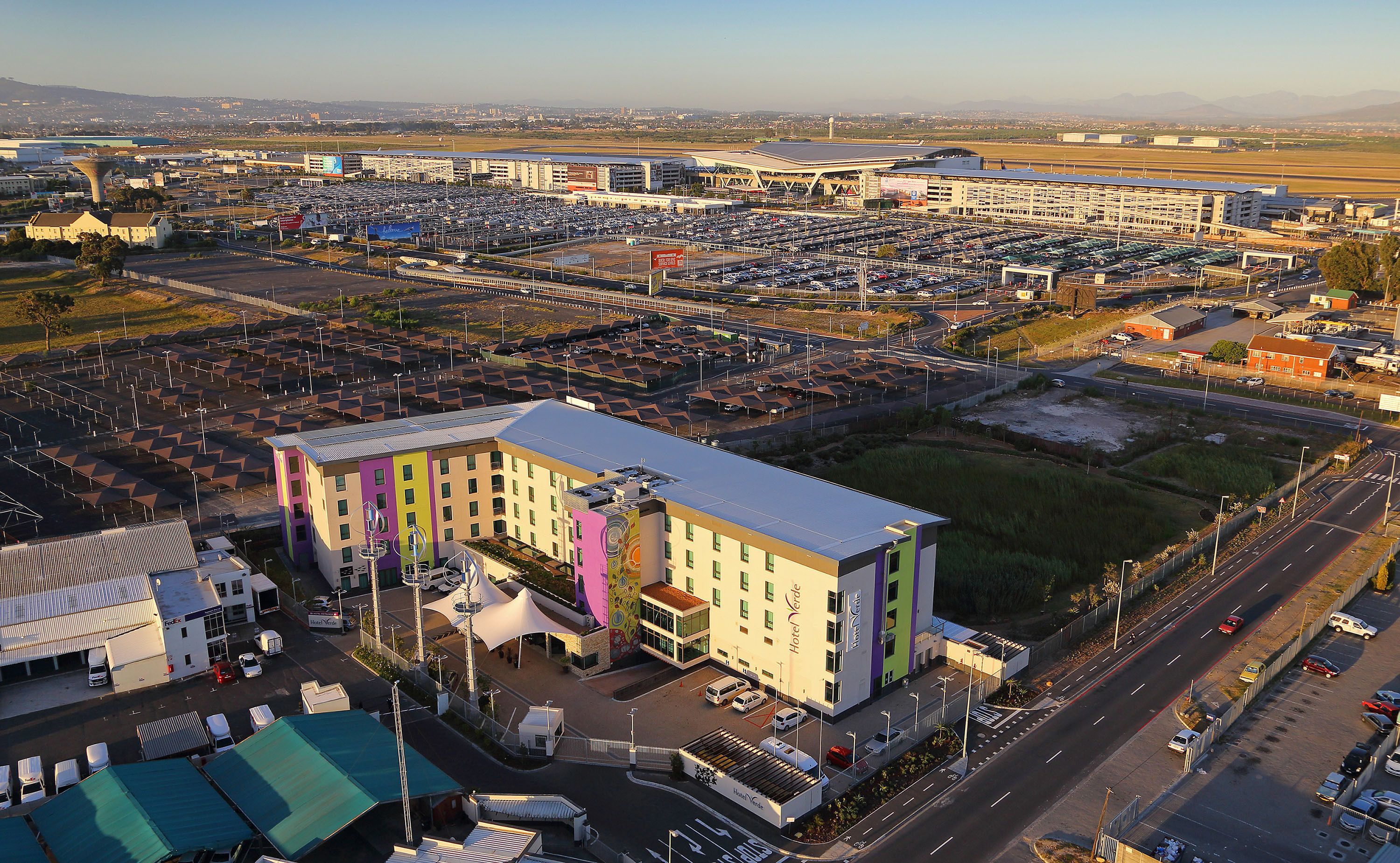 A hotel with a modern design, featuring a central courtyard and multiple floors.