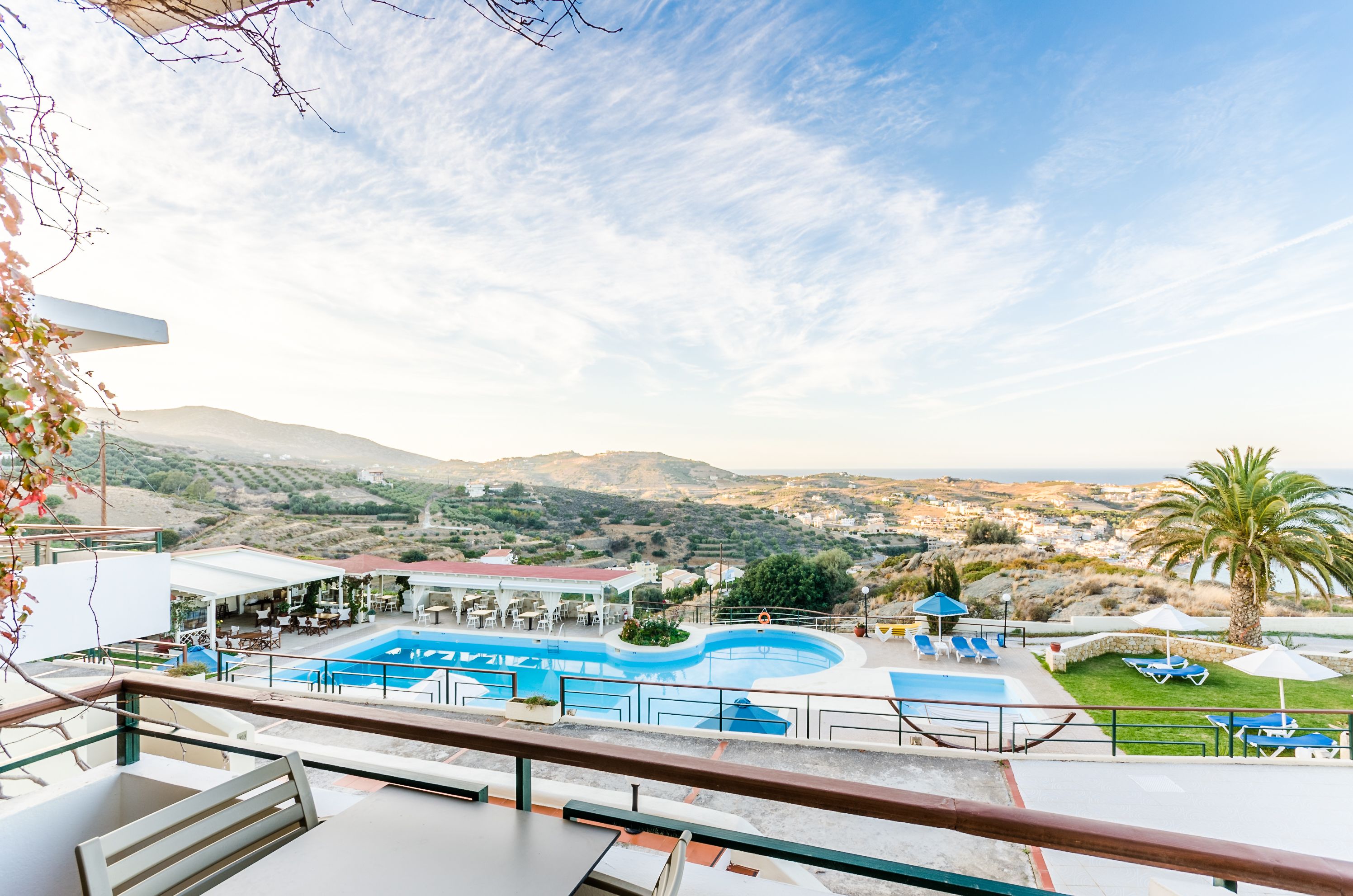 A pool area with a view of the landscape.
