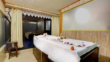 Relax in comfort with a plush bed, a beautiful floral arrangement, and a peaceful view.