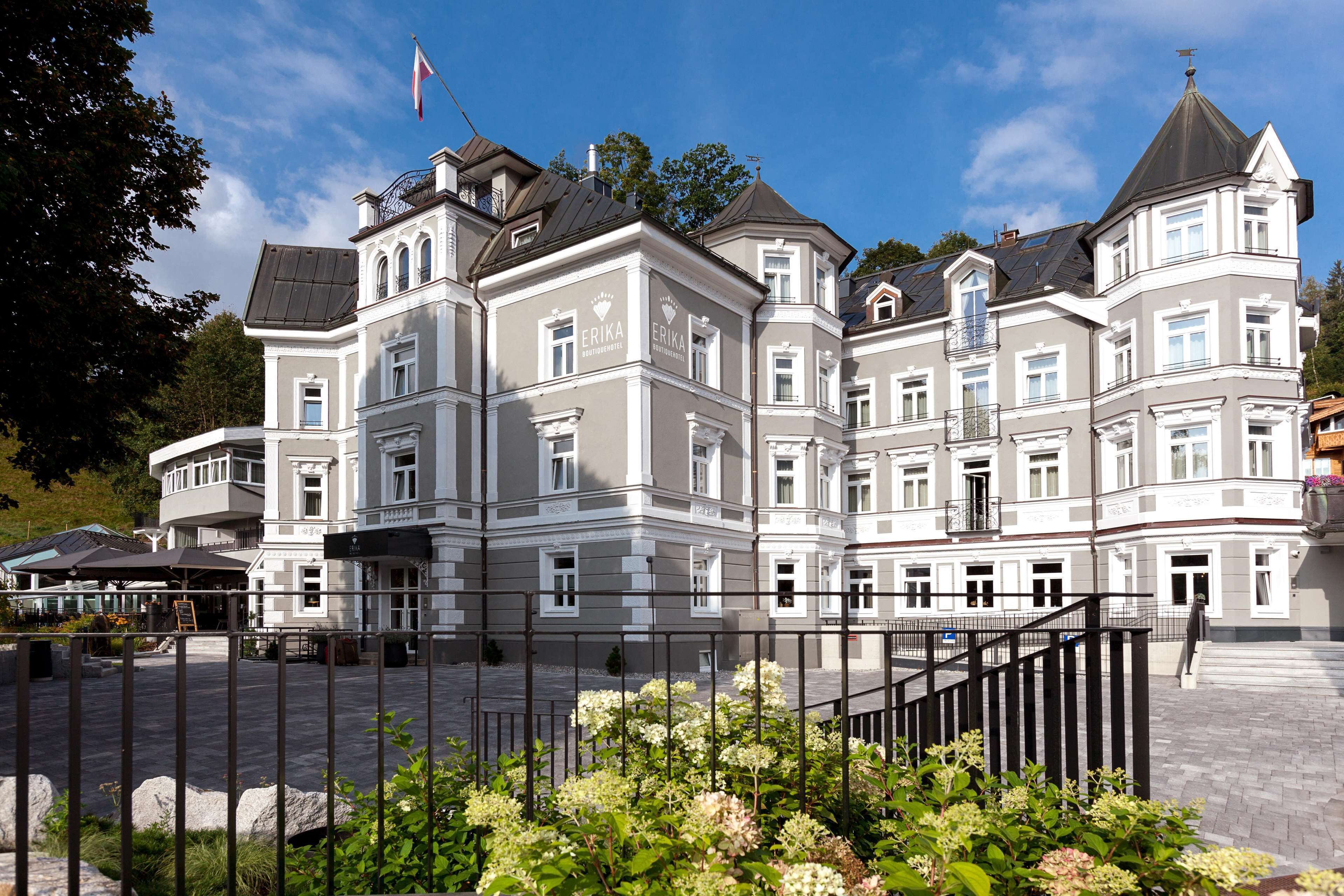 A large, historic building with multiple balconies and a central entrance.