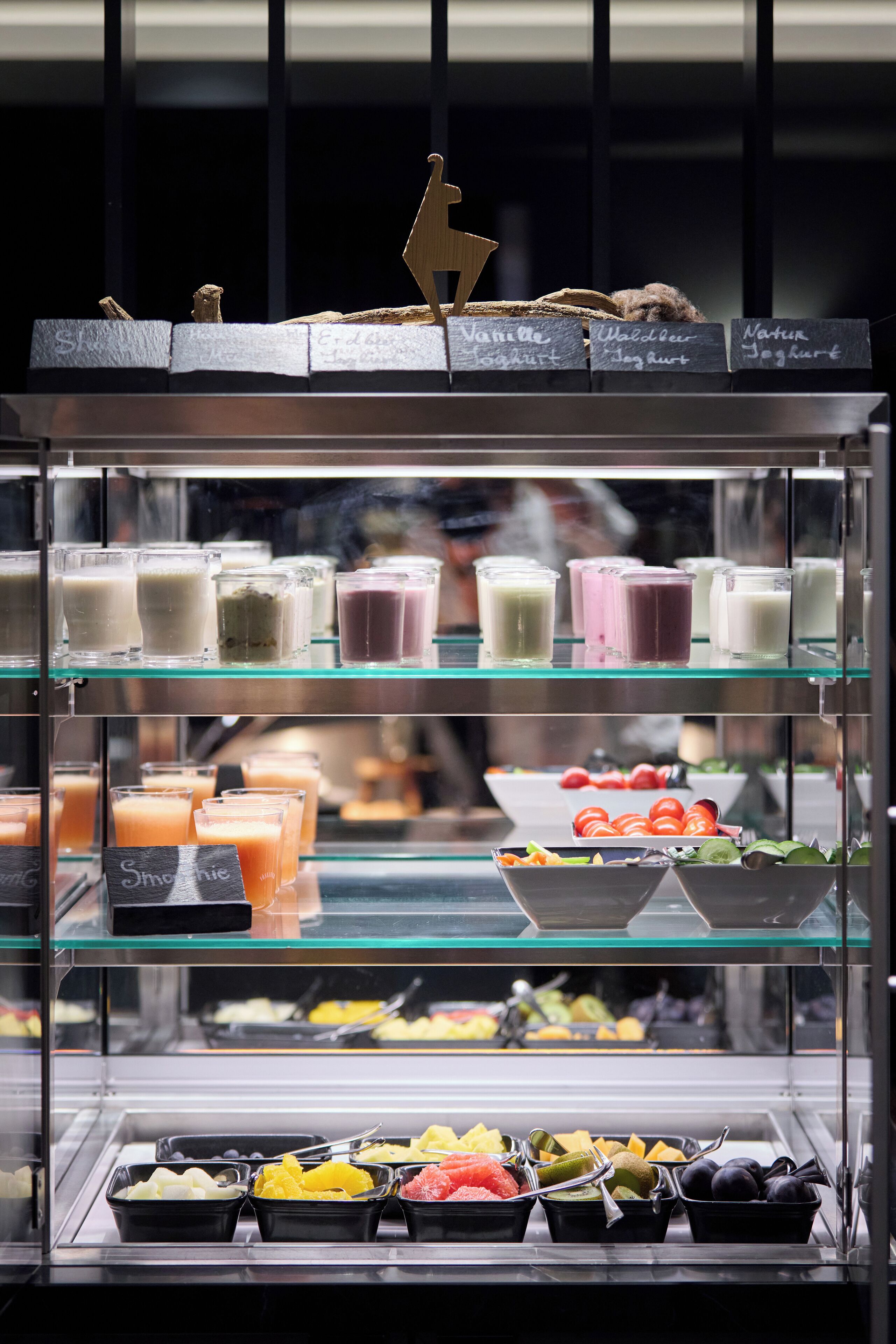 A food display with various drinks and fruits.