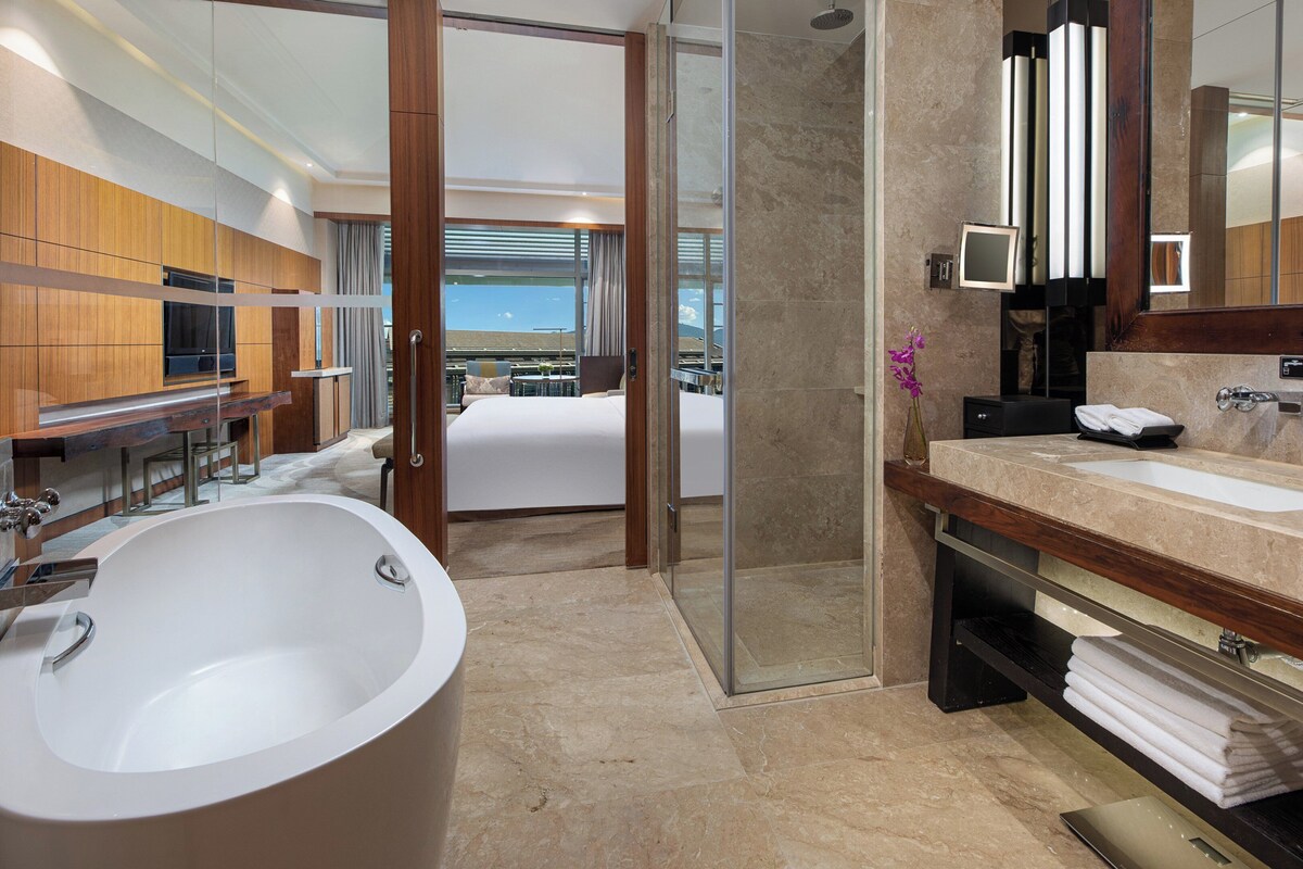 Un baño moderno con una bañera grande, lavamanos dobles y una zona de ducha.