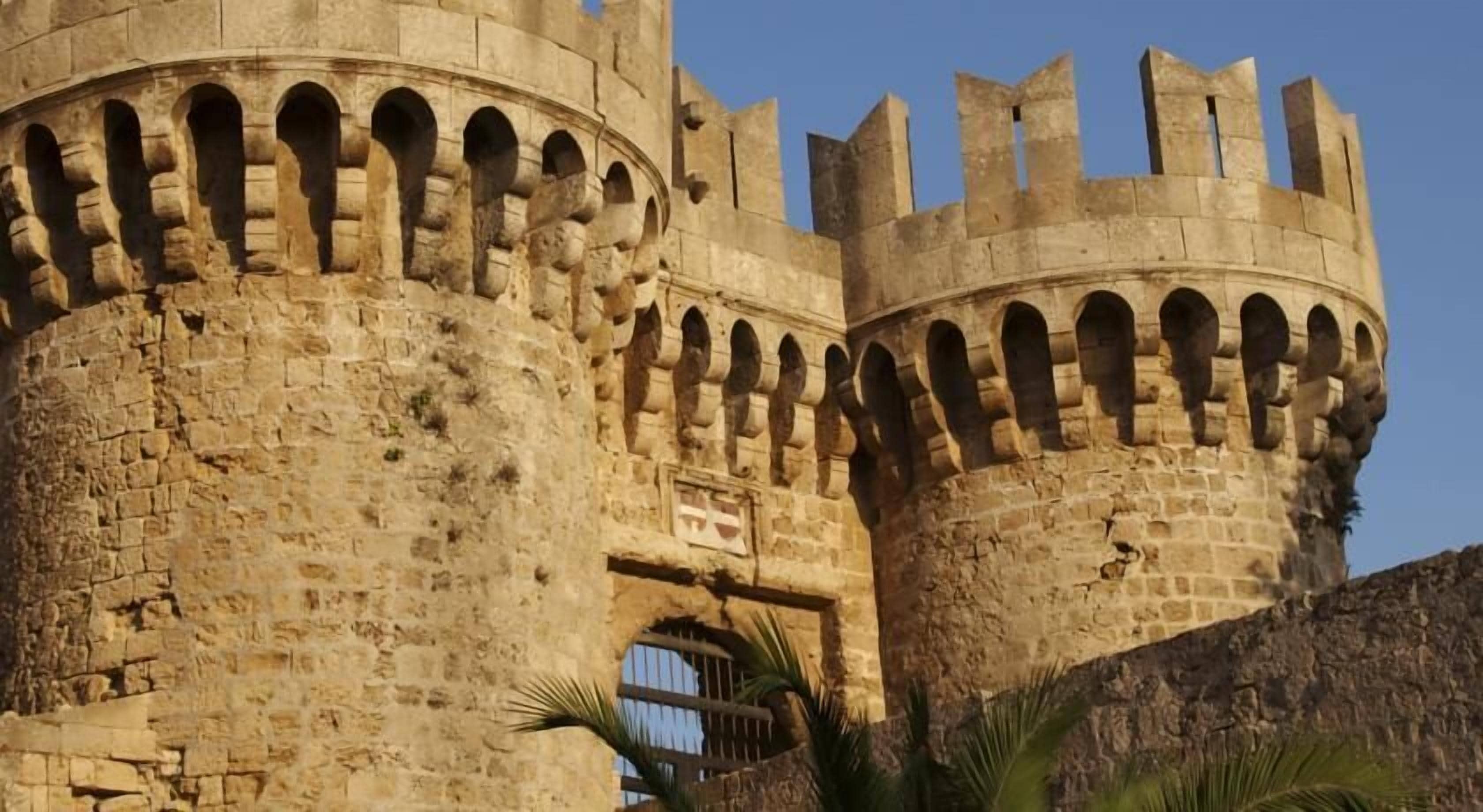 A historic stone castle with arched windows and battlements.