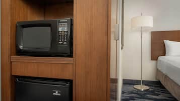 A compact kitchenette with a microwave and a mini refrigerator.