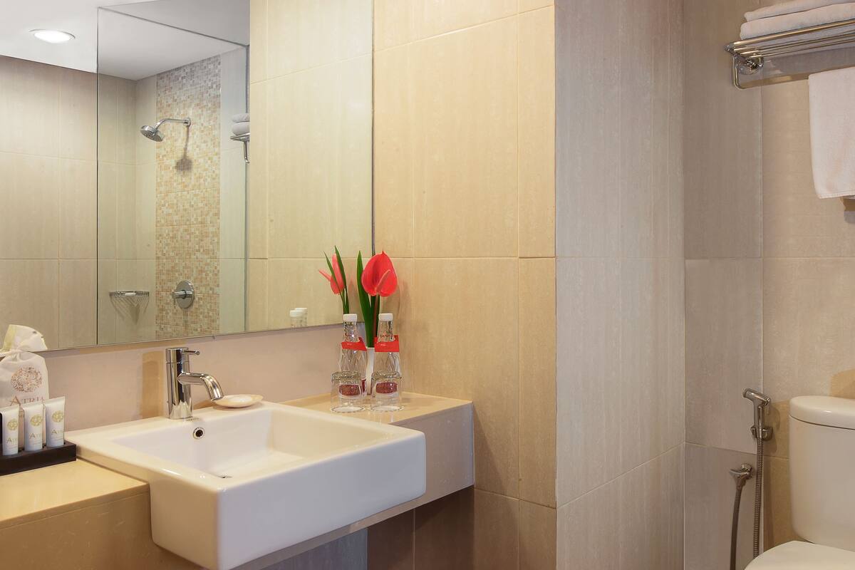 shower, hair dryer, slippers, towels