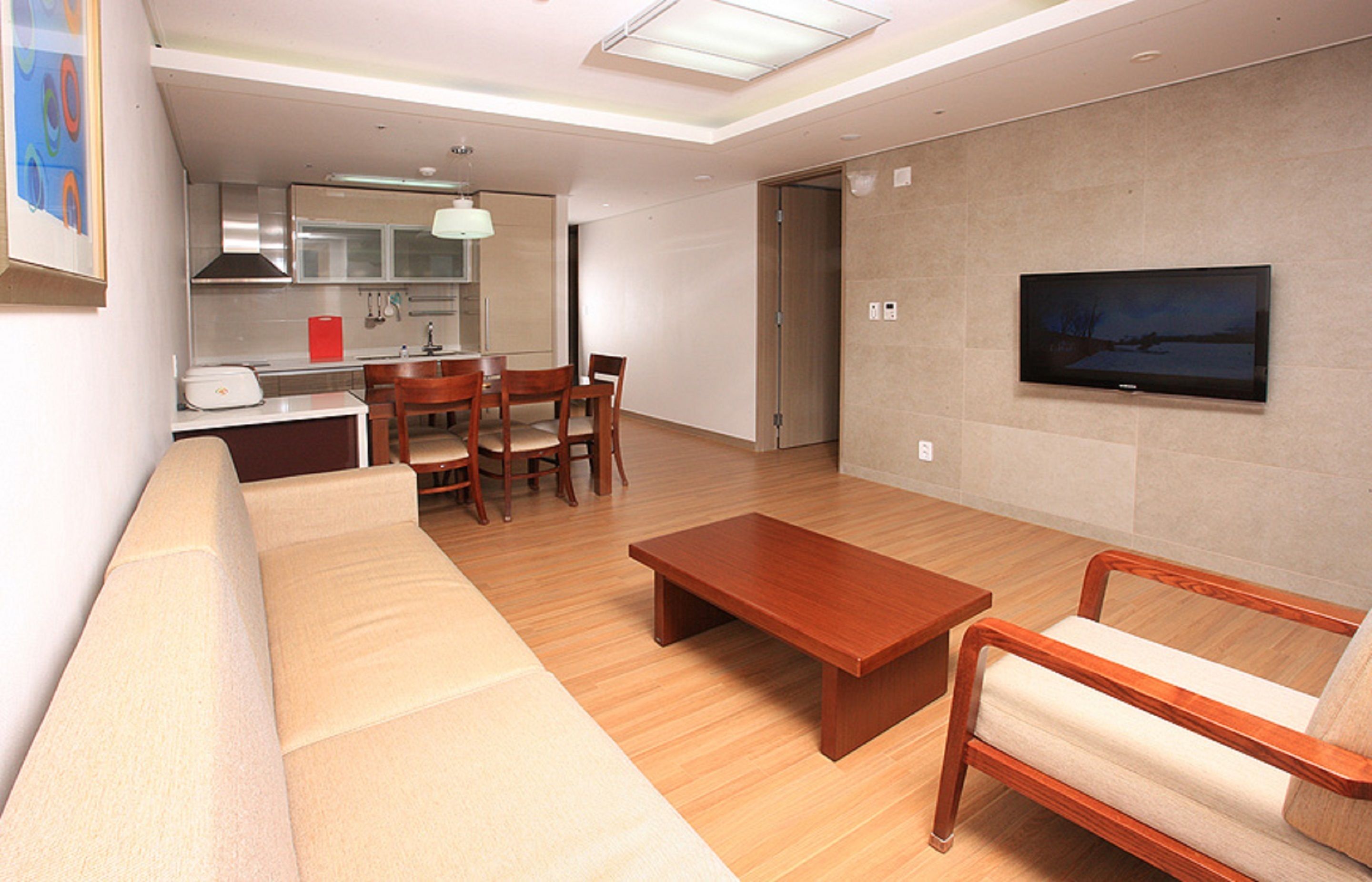 A modern living room with a sofa, coffee table, and TV.