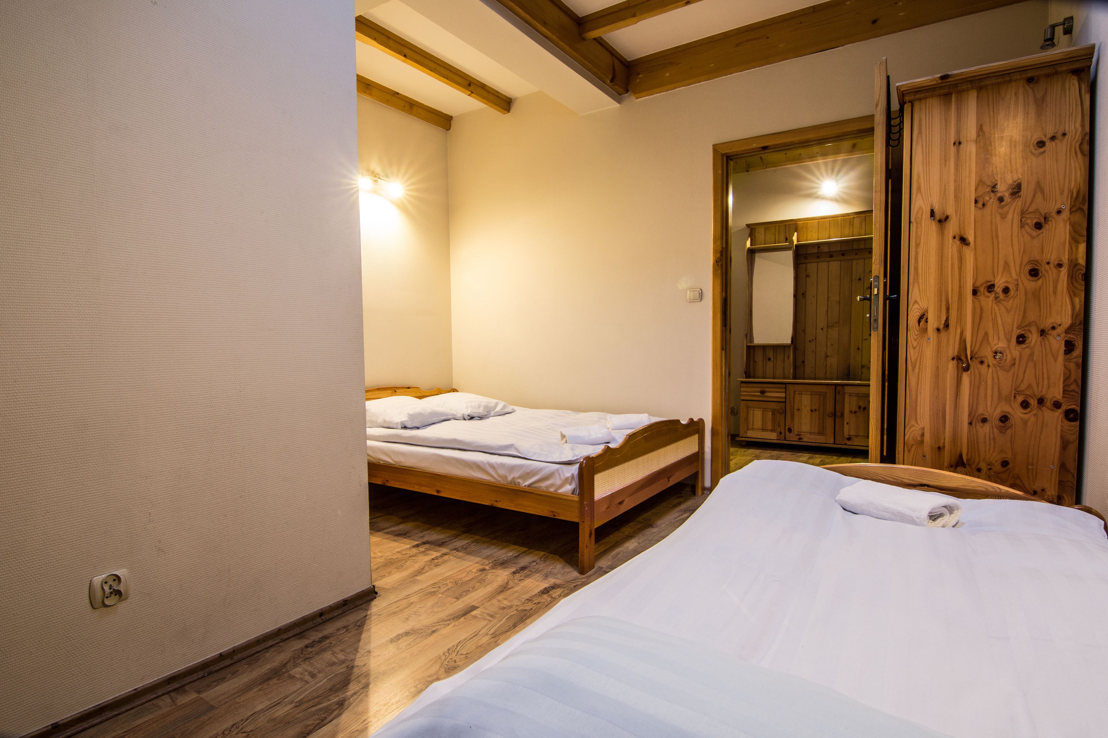 Un dormitorio con cama, armario y techo de madera.