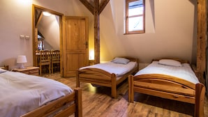 A bedroom with three wooden beds, a wooden wardrobe, and a small window. - Top Hostel (Zakopane)
