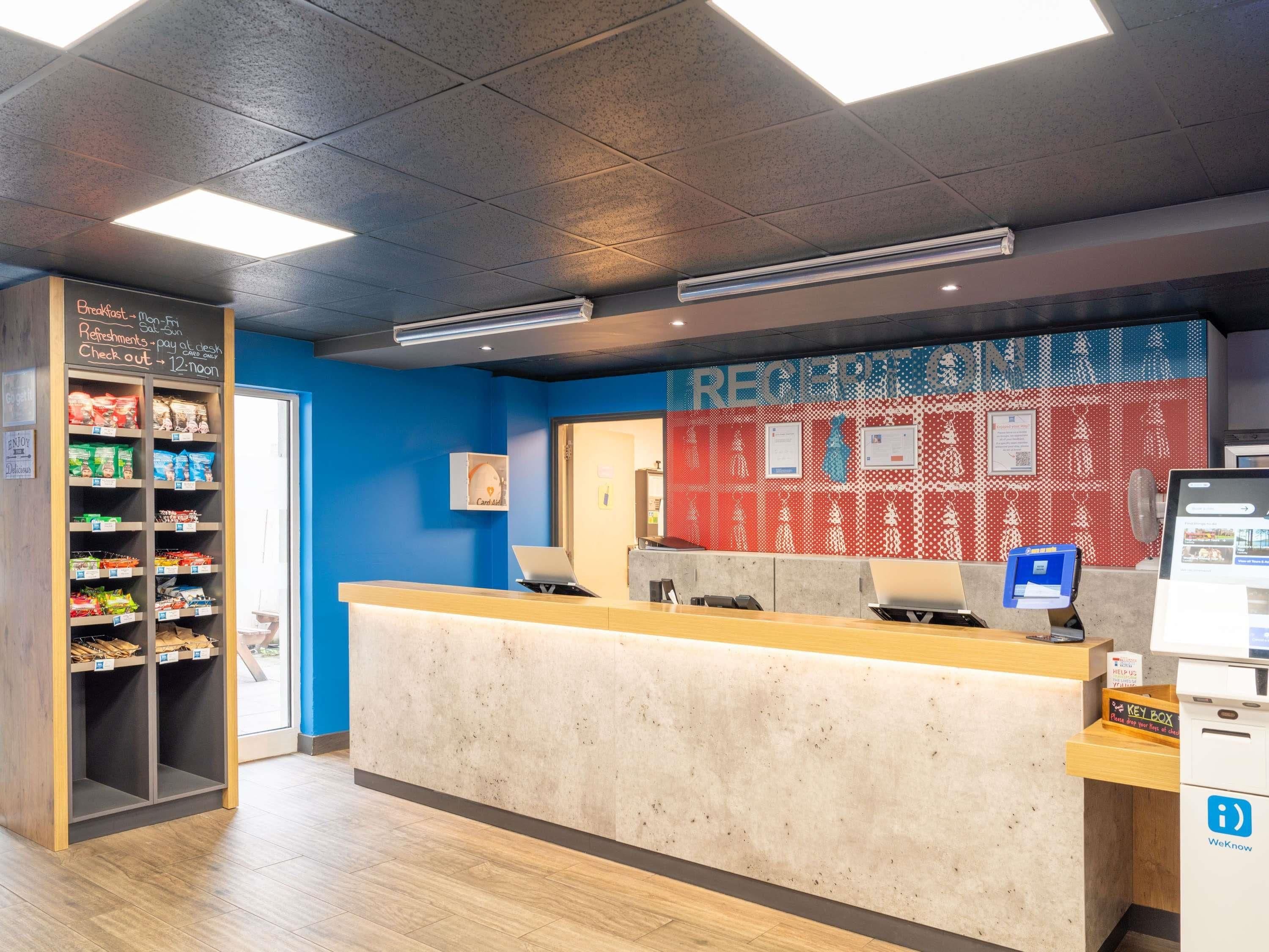 A reception area with a counter, a card reader, and a WeKnow sign.