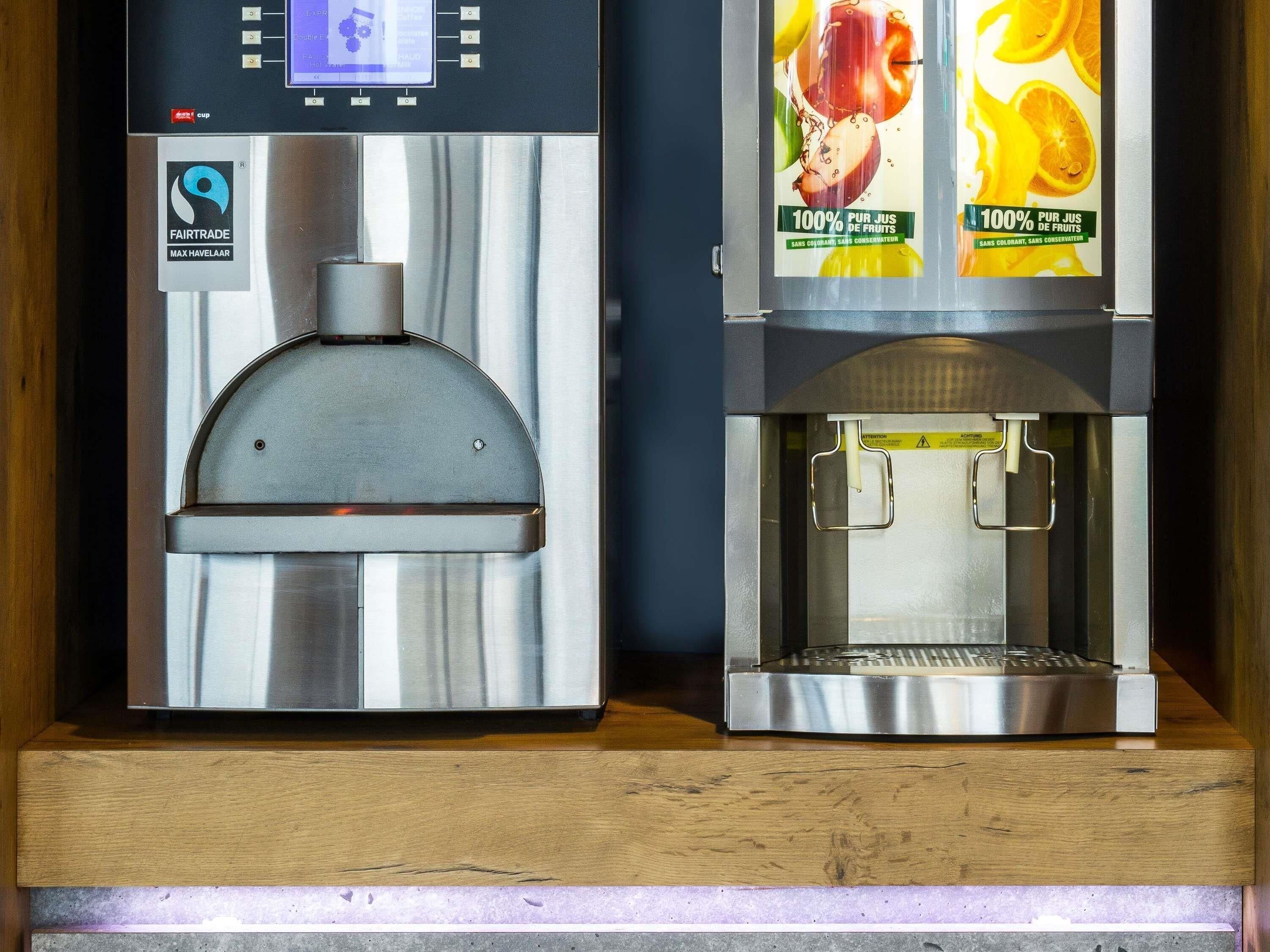 A coffee machine with a digital display and a water dispenser.