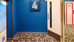 A hallway with a blue wall, a sign with the number 4, and a door labeled 401.