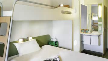 A bunk bed with a bedside table, a green bag, and a tablet on the bed.