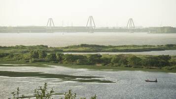 A river with a bridge in the background and a boat in the foreground.