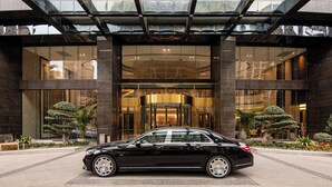 A black car parked in front of a building with a glass entrance and a modern design. - Holiday Inn Ningde Xiapu by IHG (Ningde)