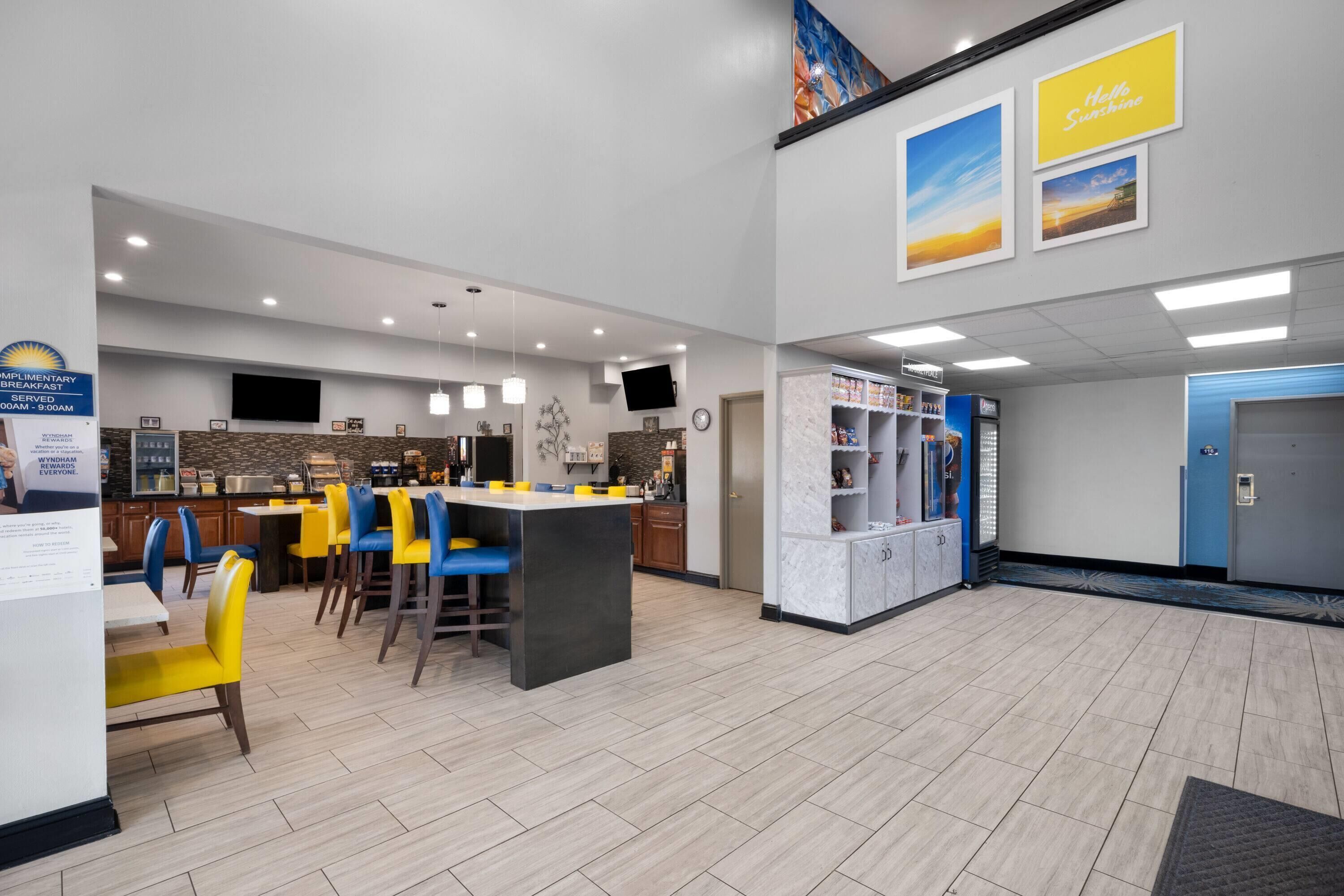 A hotel lobby with a bar area, seating, and a vending machine.