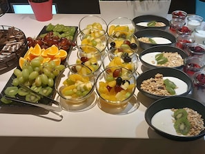 A buffet table with various fruits, yogurt, and granola. - ibis Styles Liverpool Centre Dale Street (Liverpool)