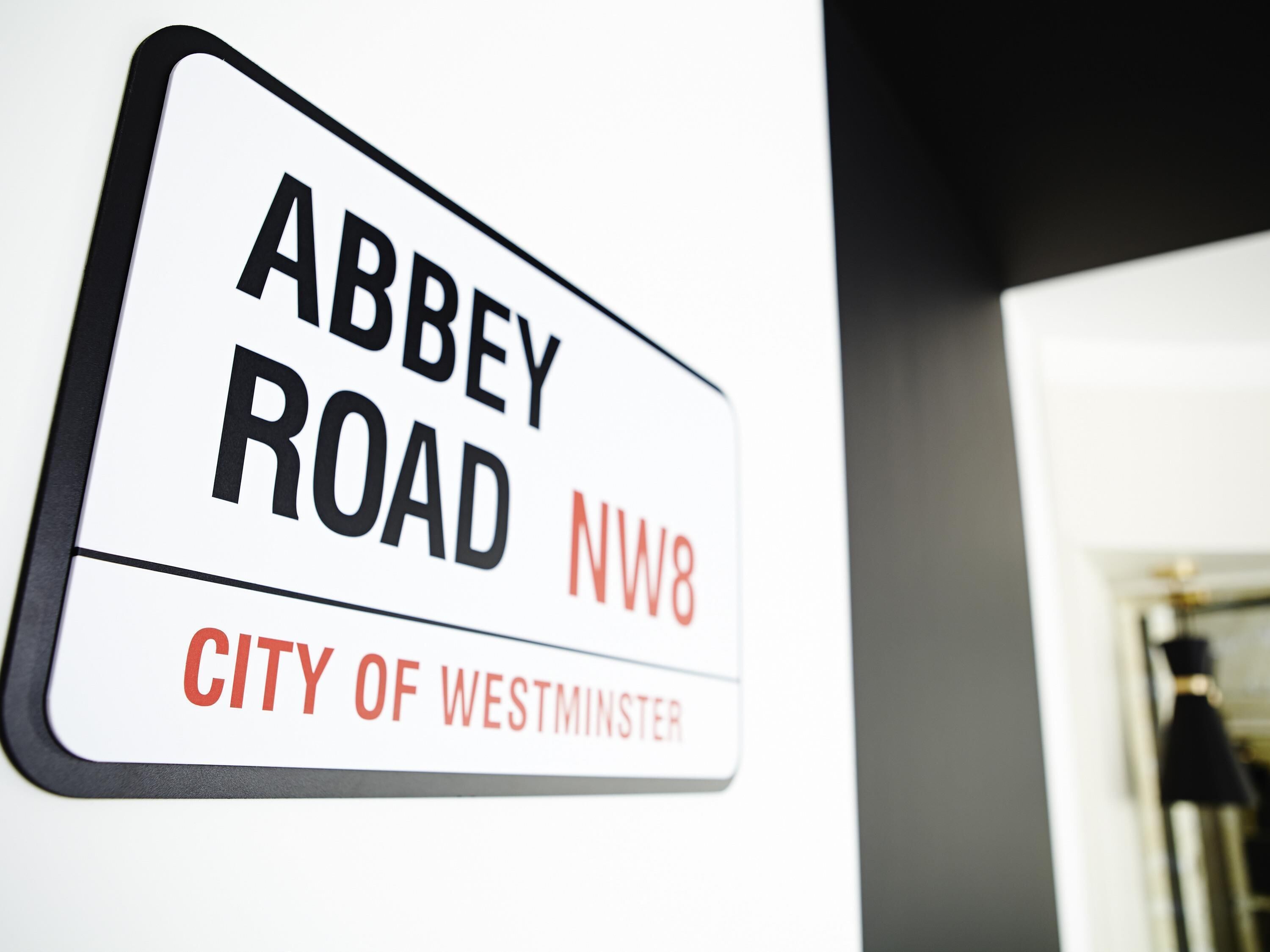 A sign with 'Abbey Road NW8' and 'City of Westminster' indicating a location.
