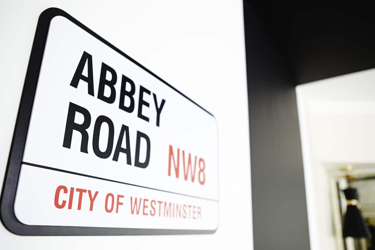 A sign with 'Abbey Road NW8' and 'City of Westminster' indicating a location.
