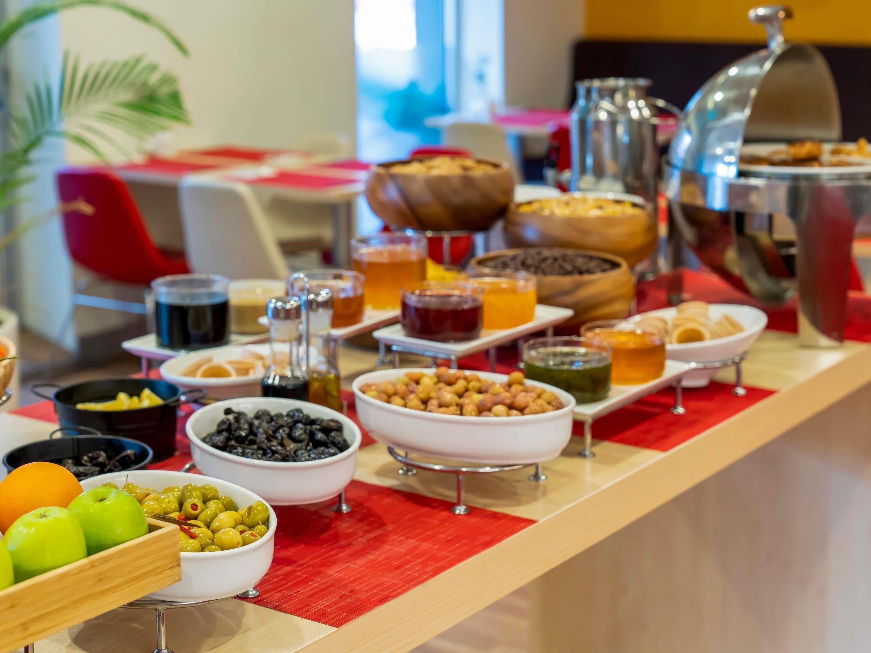 A buffet with various food items and beverages.