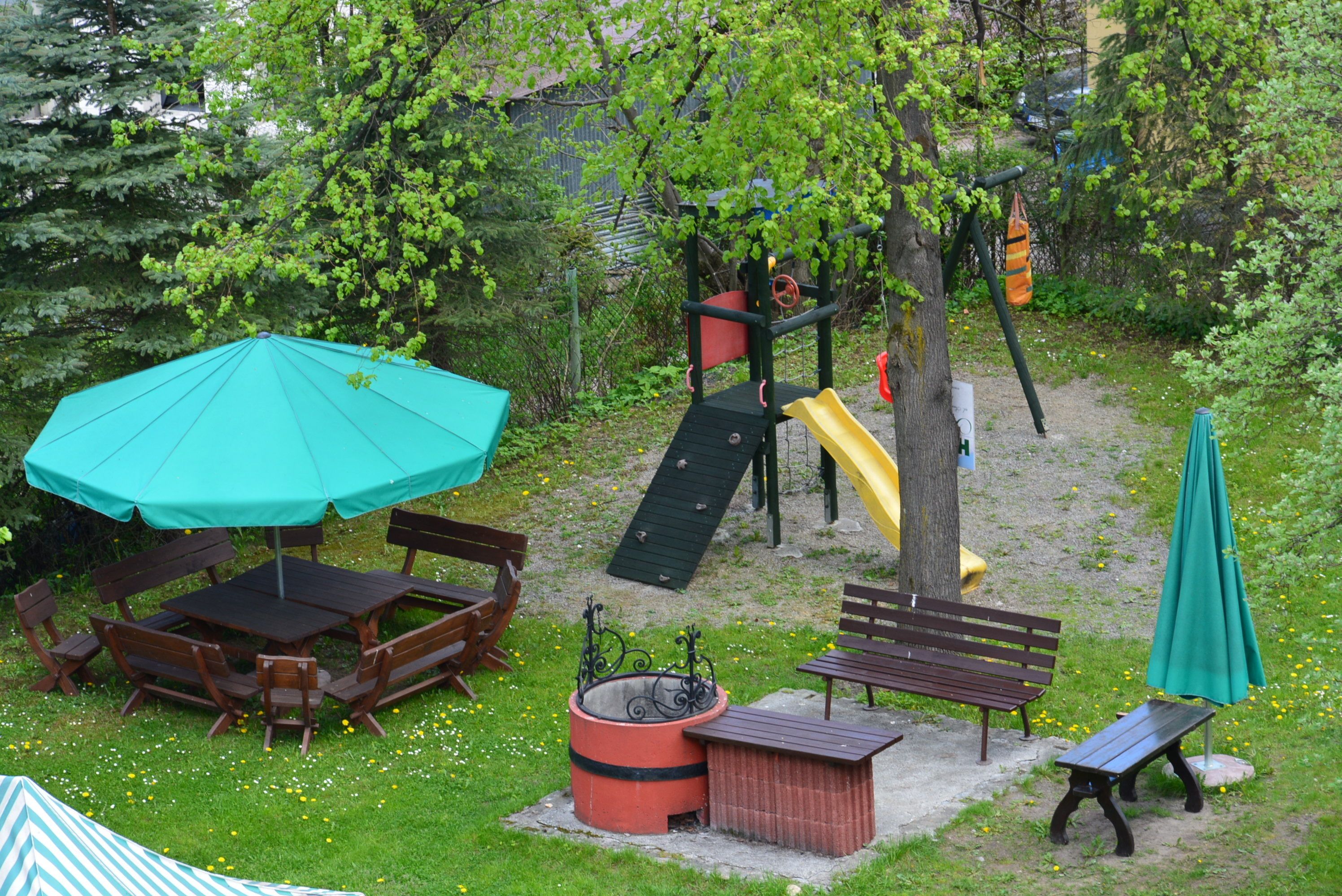 A playground with a slide, swings, and a climbing structure.