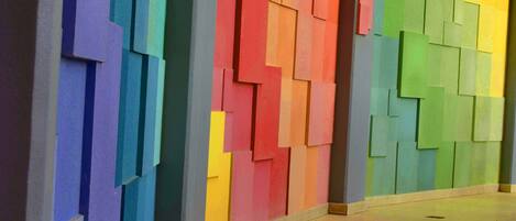 A hallway with colorful, geometric wall panels.