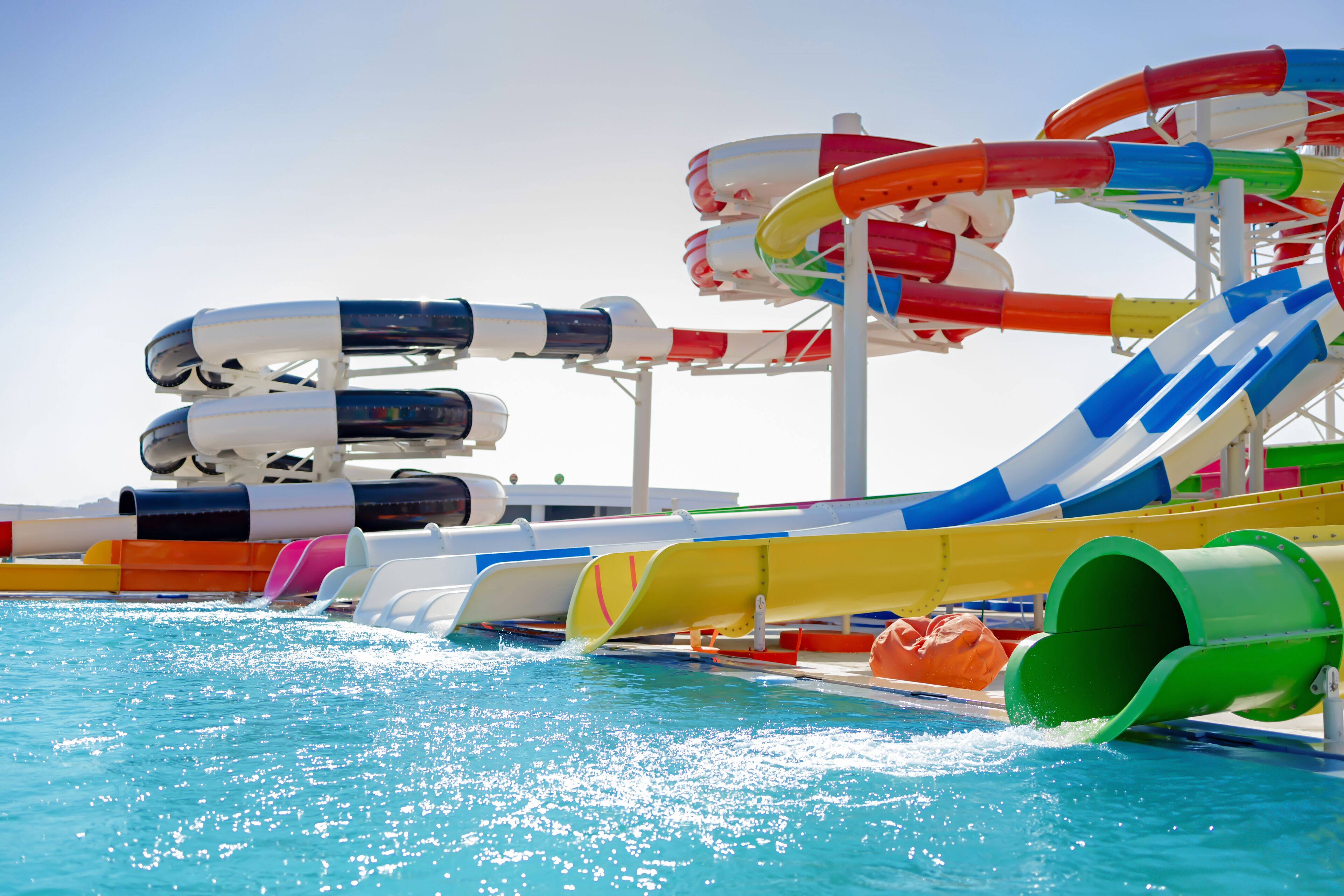 A water park with multiple slides and a pool.