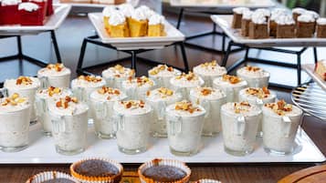 A buffet with various desserts including cakes and cupcakes.