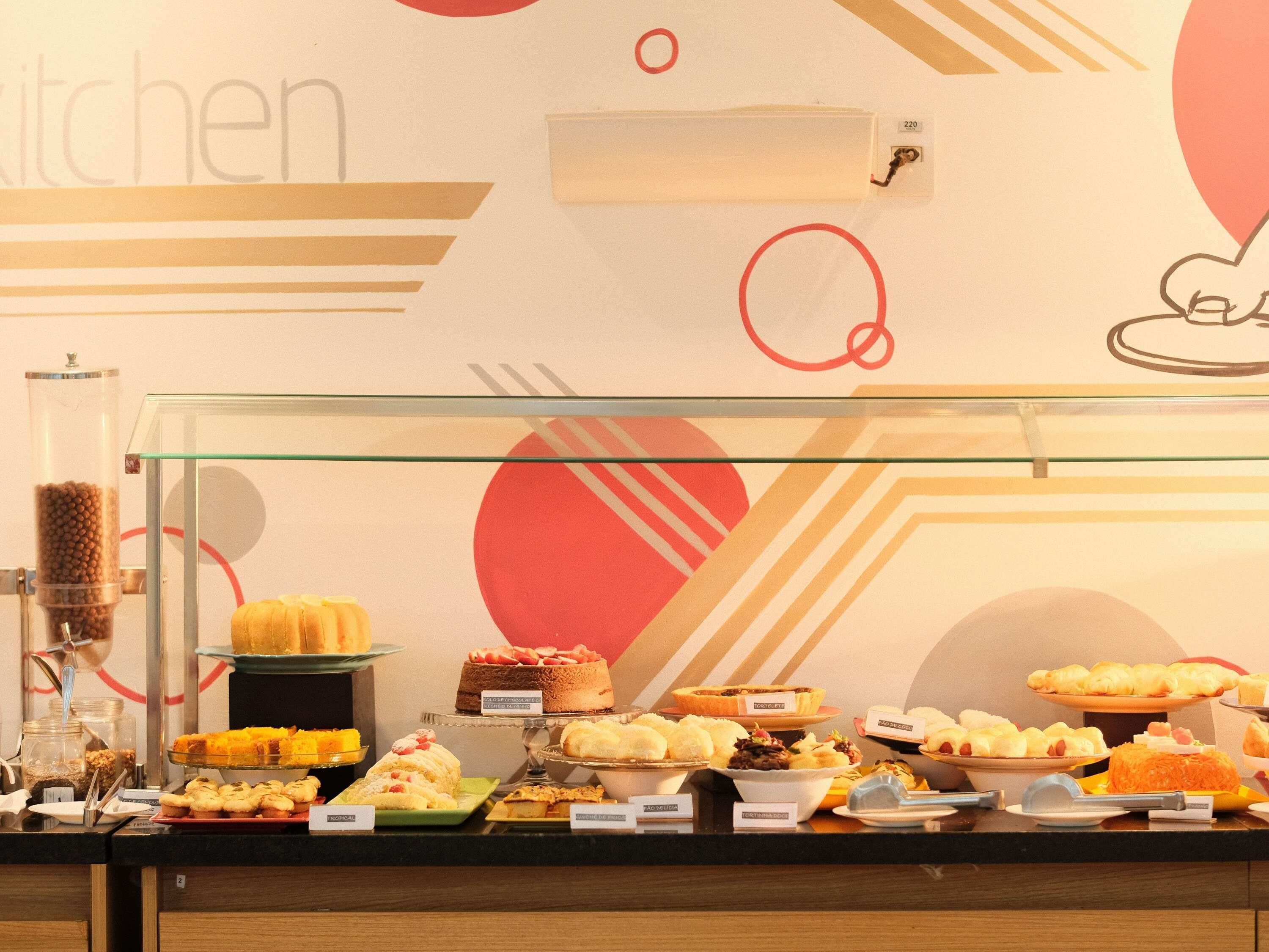 A buffet with various food items and a coffee machine.