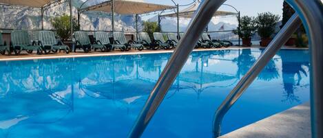 Outdoor pool, open 9:00 AM to 8:00 PM, pool loungers