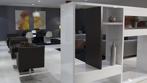 A modern hotel lobby with a reception desk, seating area, and decorative elements like a vase and abstract art. - Hotel K10 (Urnieta)