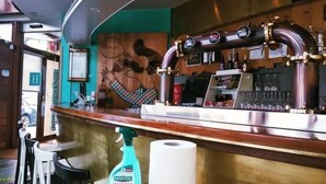A bar area with a counter, a Sanytol hand sanitizer bottle, and a roll of toilet paper. - Hostal Bríos (Lugo)