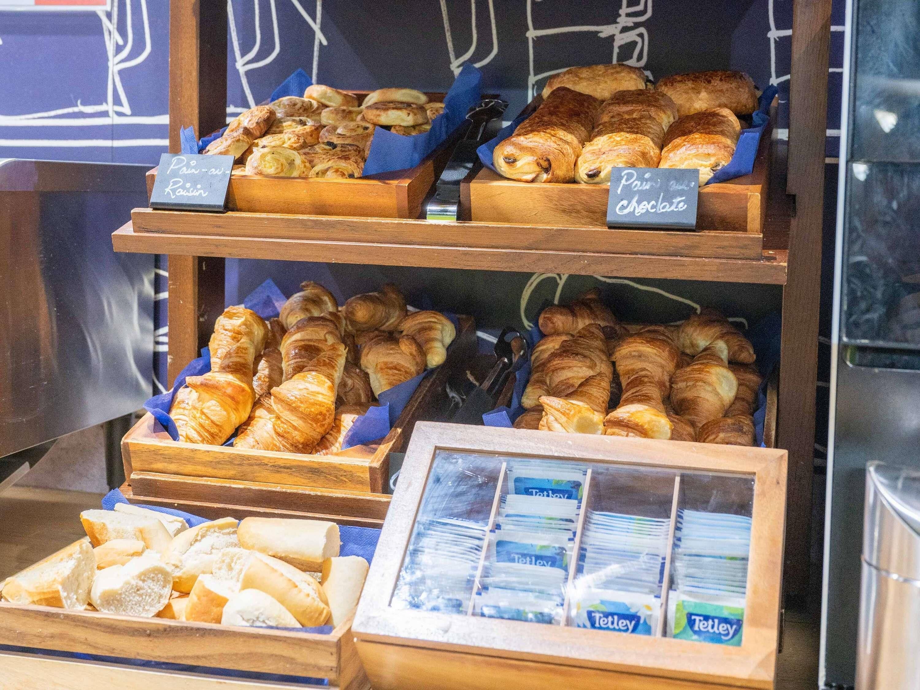 A bakery display with various baked goods, including bread and pastries.