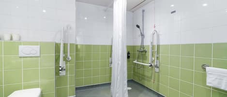A bathroom with a toilet, a shower with a curtain, and a towel rack.