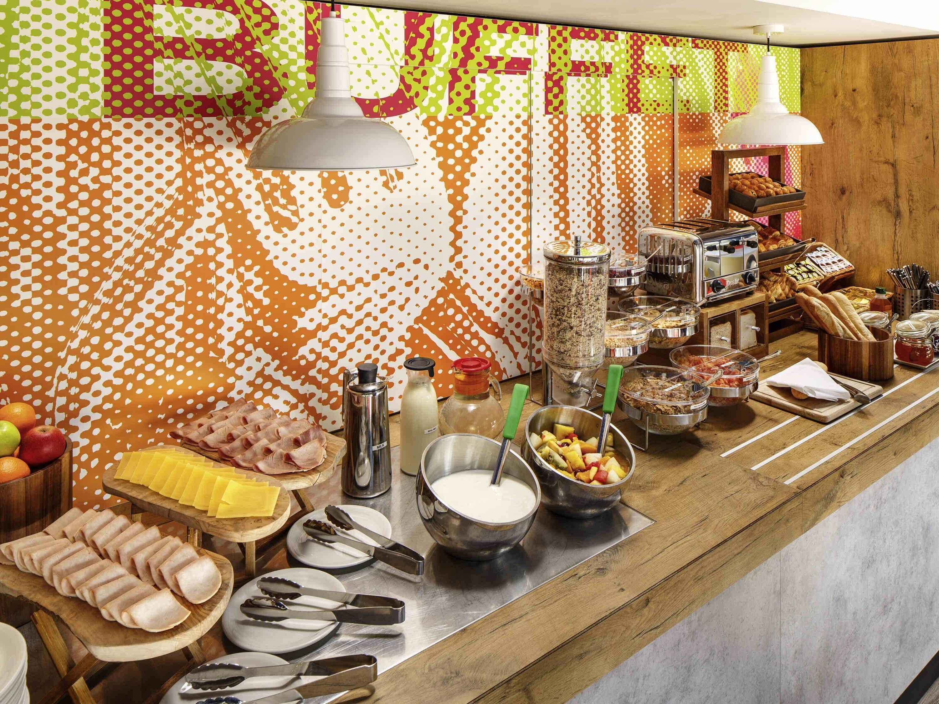 A buffet setup with various food items and utensils.