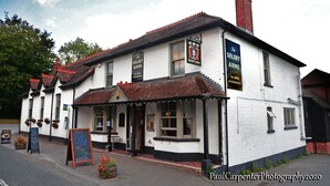 A traditional white building with a red-tiled roof, featuring signage for 'The Selsey Arms' and 'Selsey Arms'. - The Selsey Arms (Chichester)