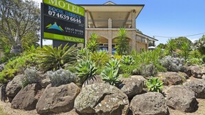 A motel with a large sign advertising a direct booking option and a vacancy. - Great Divide Motor Inn (East Toowoomba)