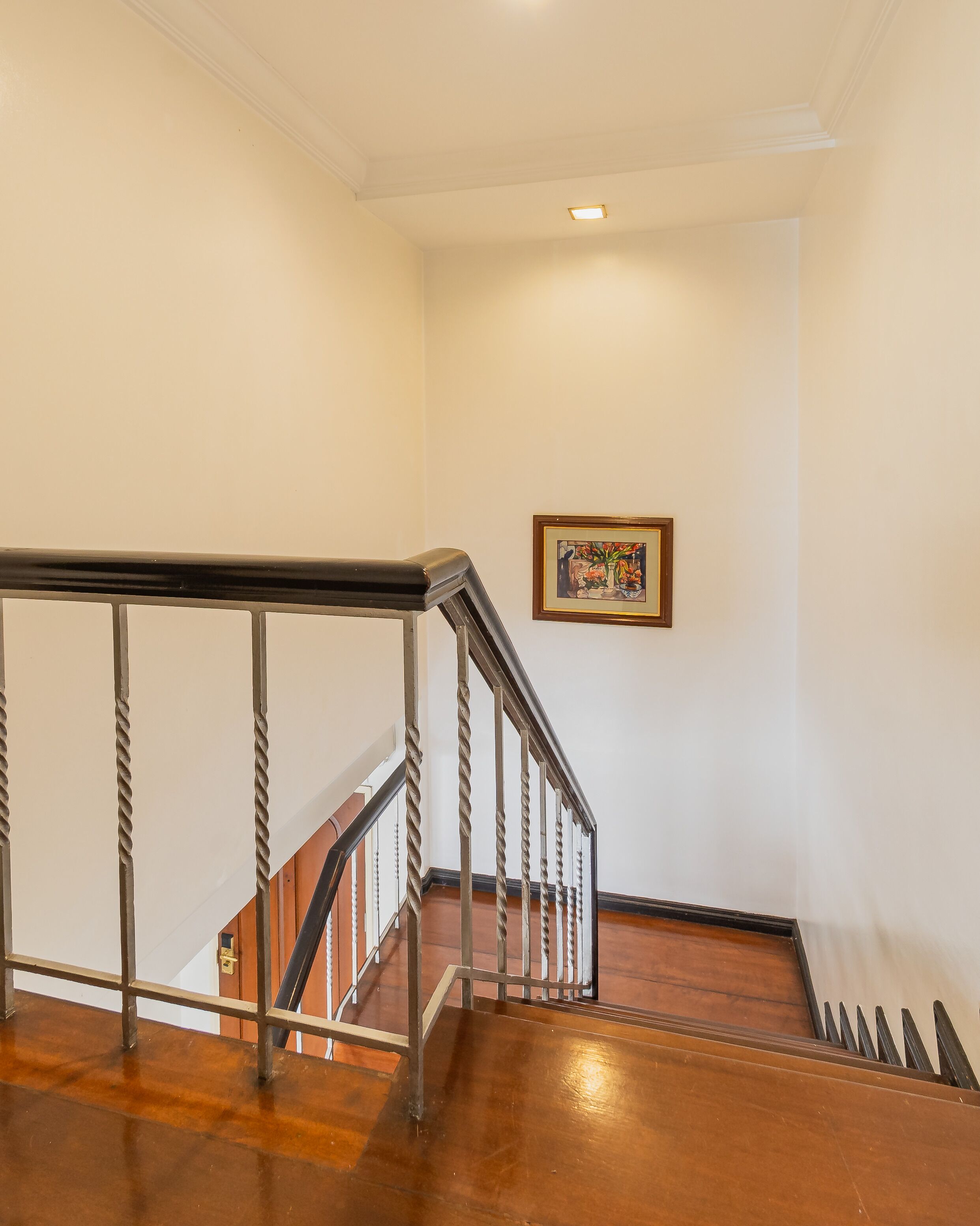A staircase with a metal railing and wooden steps.