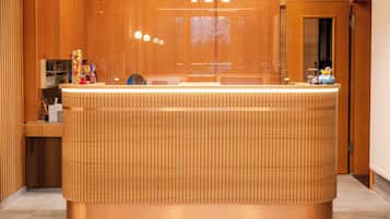 A reception desk with a wooden finish and a modern design.