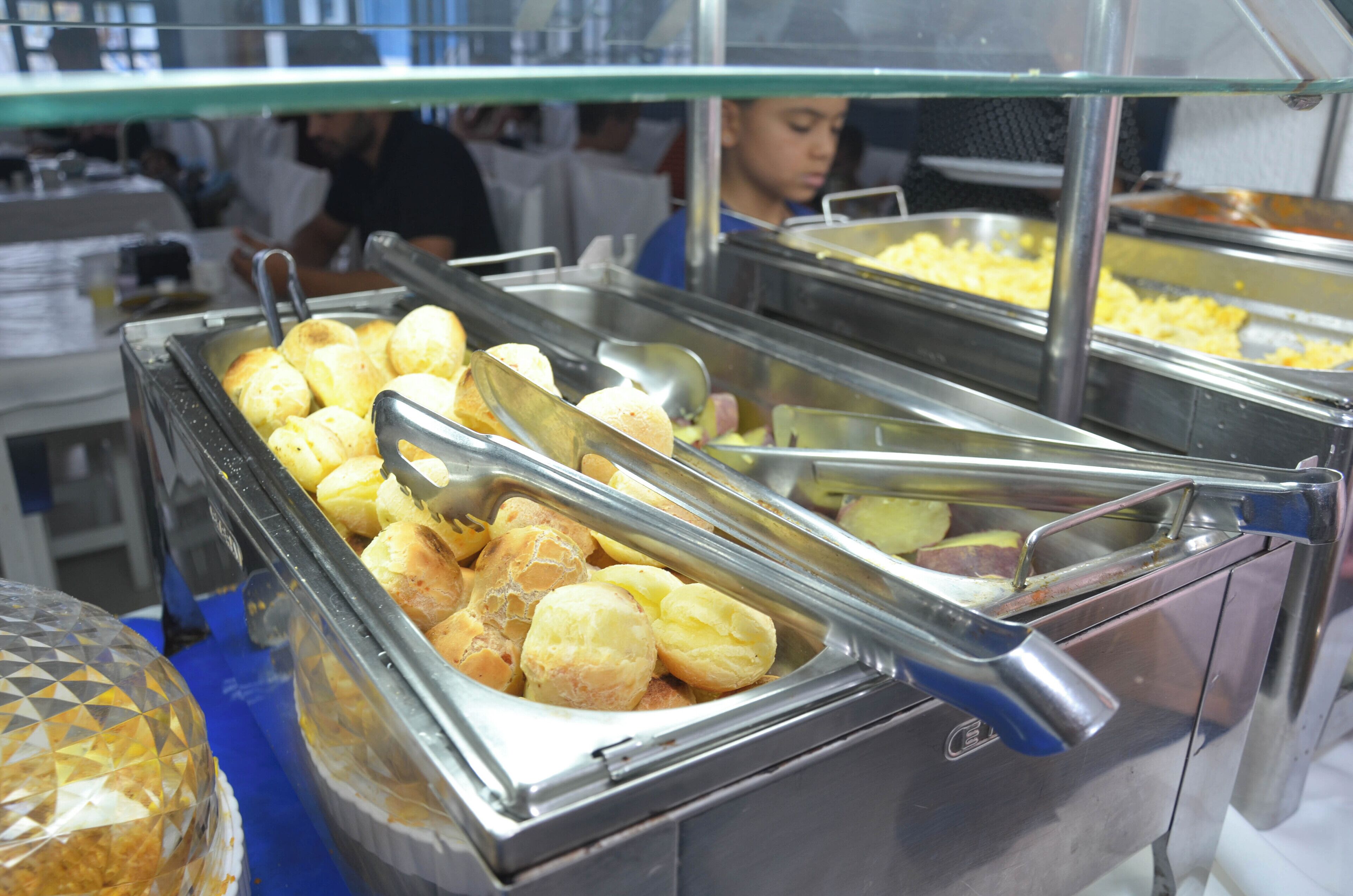 A buffet with various food items including bread rolls and other dishes.