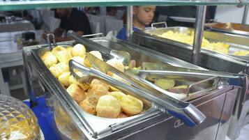 A buffet with various food items including bread rolls and other dishes.