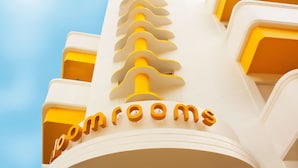 A building with a unique architectural design featuring a series of yellow and white elements.