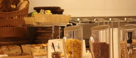 Montaje de bufé con diferentes alimentos y recipientes.